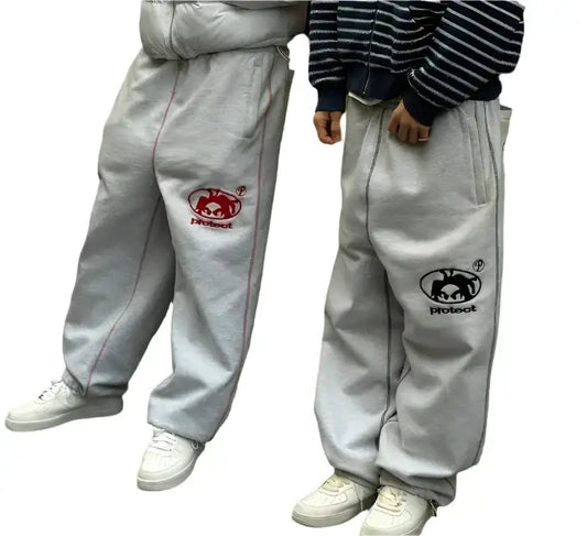 White wide leg sweatpants featuring playful cartoon crab logos on the thighs