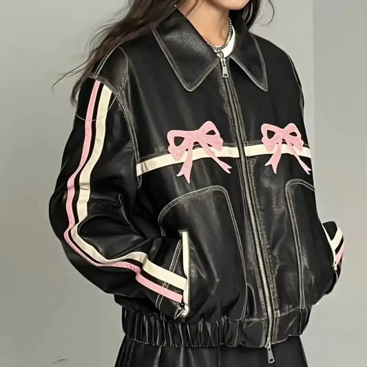 Black leather Woman Moto Jacket with pink bow accents and white stripes on sleeves