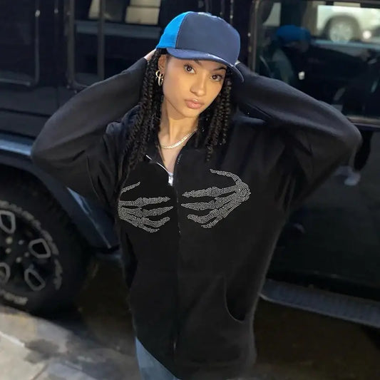 Person in Y2K aesthetic hoodie, black hoodie and blue cap with long braids