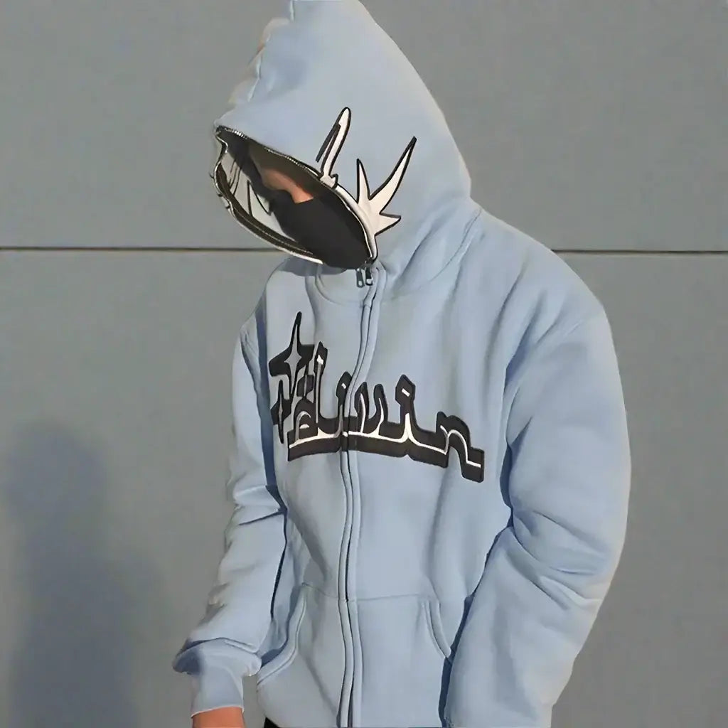 Light blue Y2K Arabic hoodie with stylized text and a unique metallic mask design