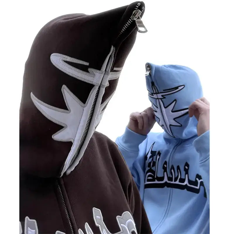 Two Y2K Arabic Hoodies in brown and light blue with unique face designs on hoods