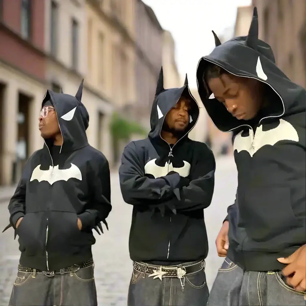 Three people in Y2K Batman Hoodies with pointed ears and bat logos