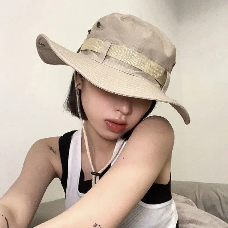 Beige Y2K bucket hat with a ribbon band worn at a stylish tilted angle