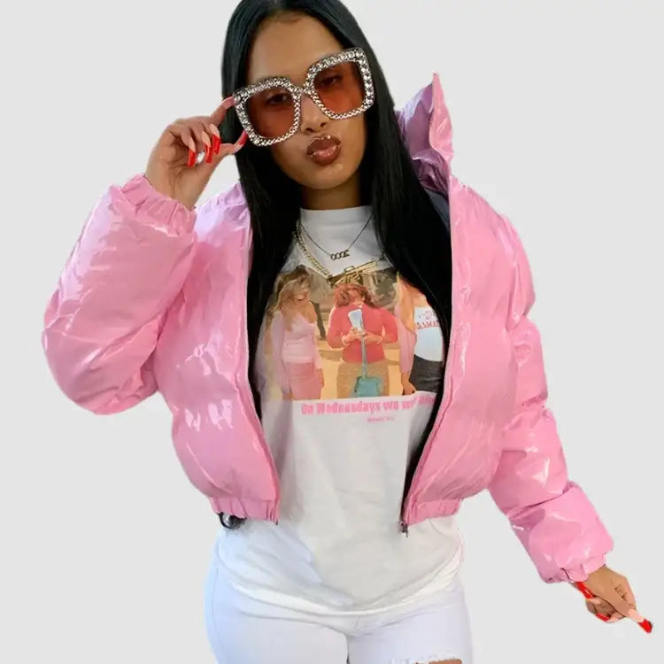 Woman in pink Y2K cropped jacket, graphic tee, and oversized rhinestone sunglasses