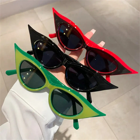 Cat-eye sunglasses in vibrant green, black, and red for Y2K fashion style