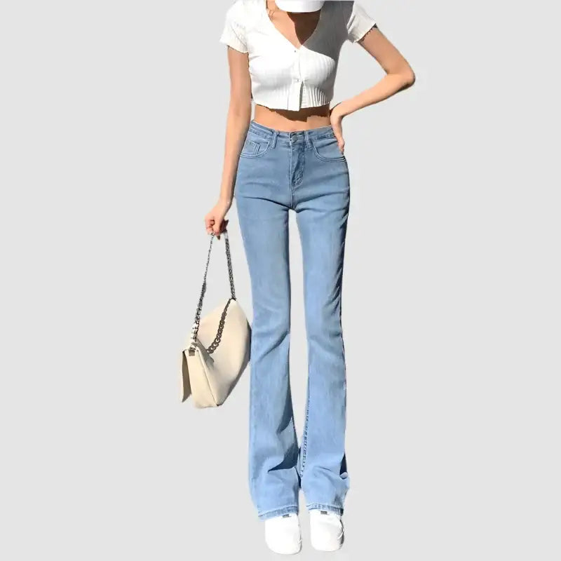 Light blue Y2K flare jeans styled with a chic white crop top for trendy outfits