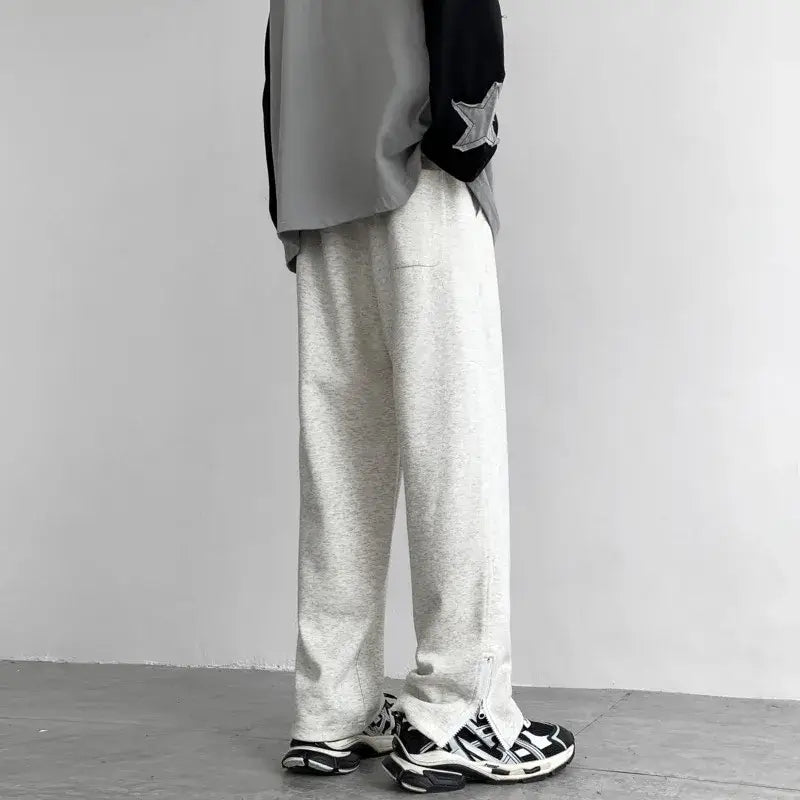 White loose-fitting Y2K flare pants paired with chunky sneakers for a trendy look