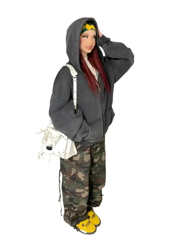 Person showcasing a Y2K Grey Hoodie with camouflage pants and yellow shoes