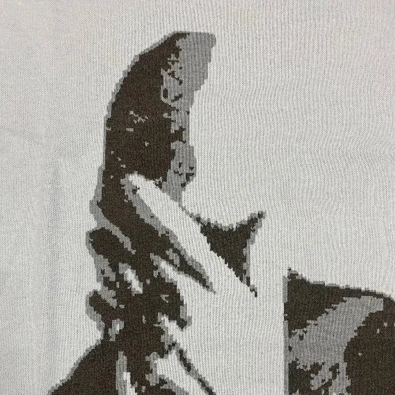 Partial view of a shark’s head on a Y2K knitted sweater in grayscale tones