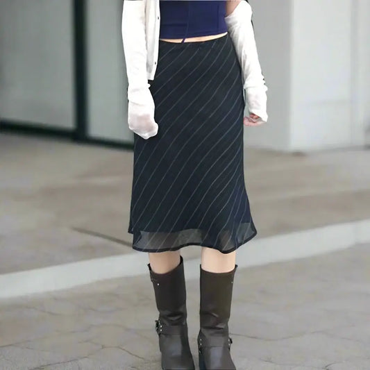 Black pinstriped Y2K midi skirt styled with knee-high boots and a white top