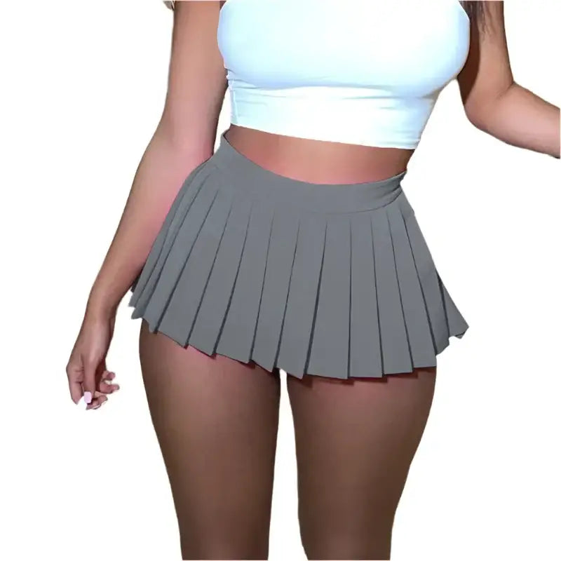 Gray pleated mini skirt paired with a white crop top in Y2K mini fashion