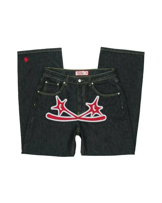 Pair of dark denim Y2K Print Jeans featuring red star designs on front pockets