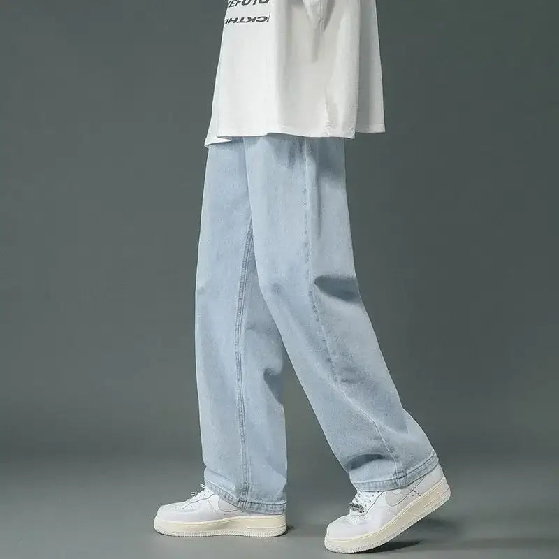 Light blue Y2K relaxed jeans styled with white sneakers and a white top