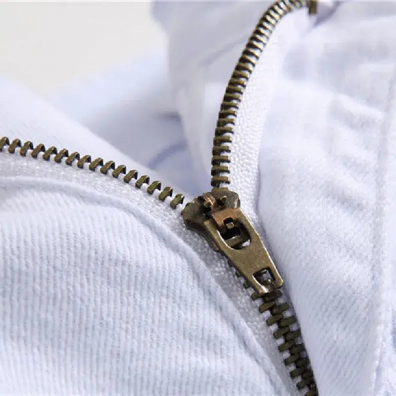 Metal zipper partially unzipped on white fabric of Y2K Skinny Jeans