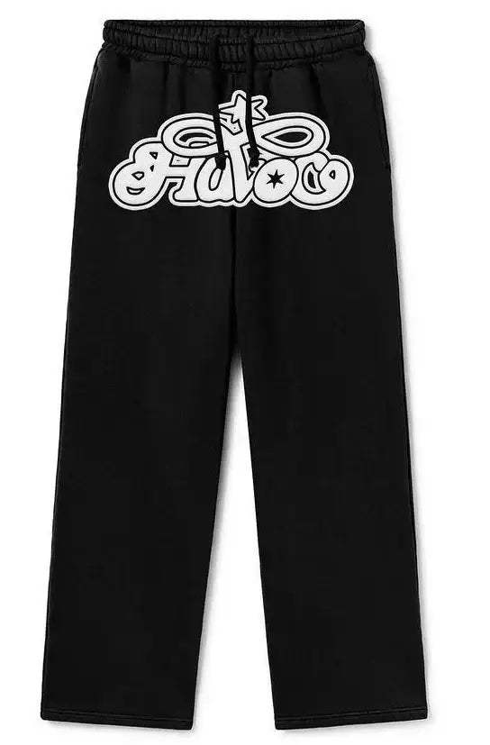 Black Y2K sweat pants with white graffiti-style logo on the left leg