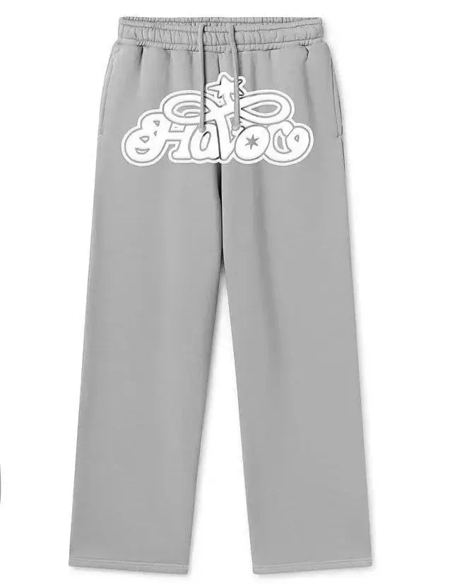 Gray Y2K sweat pants featuring a white stylized Gucci logo on the upper thigh