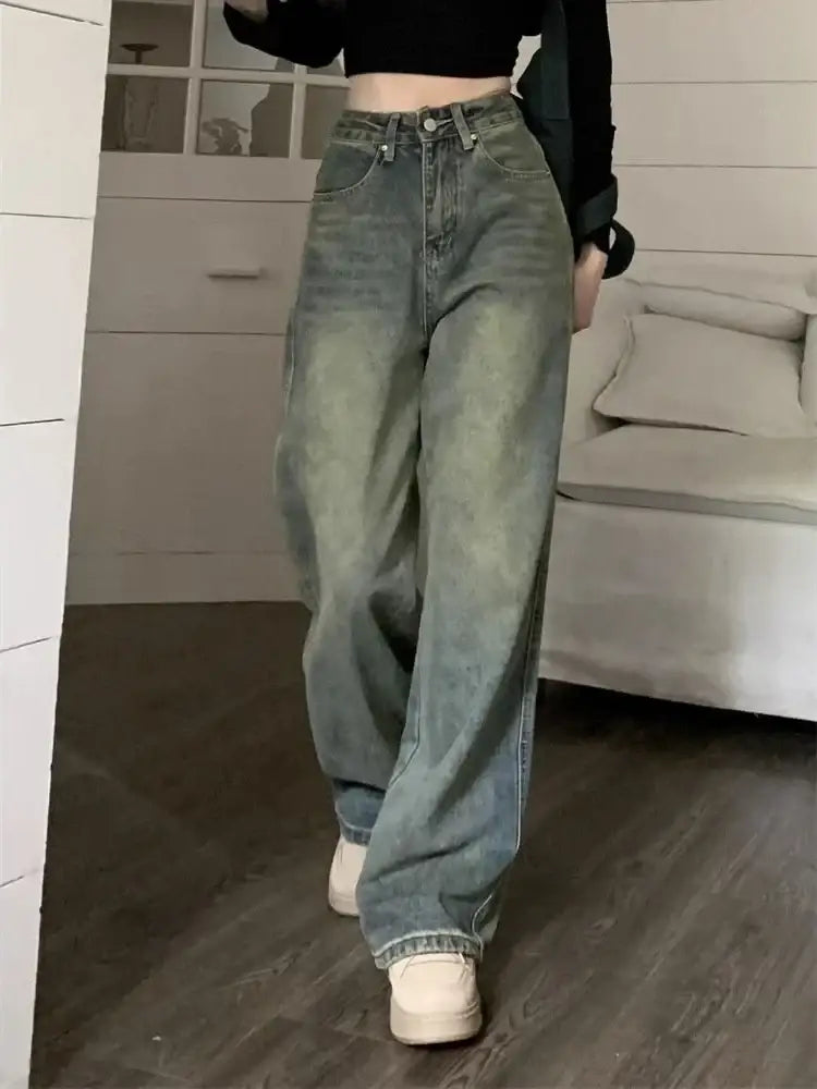 Pair of loose-fitting light-wash Y2K washed jeans with a high waist